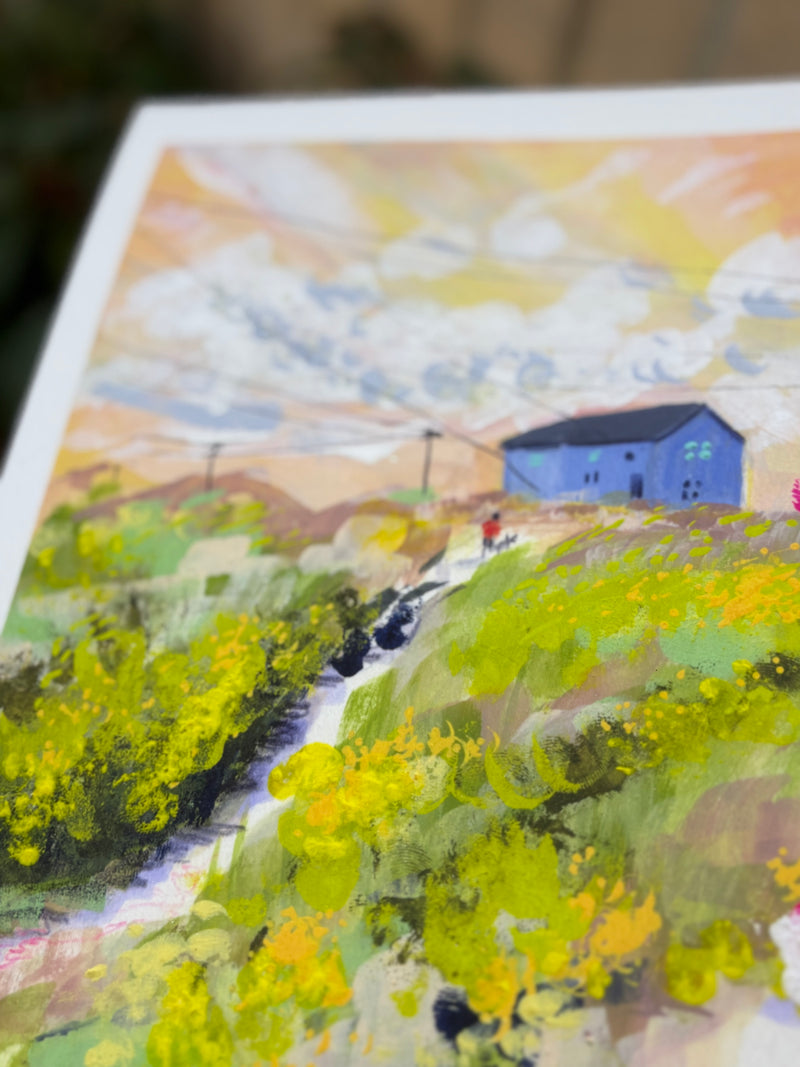 Colorful landscape painting with a blue building and greenery